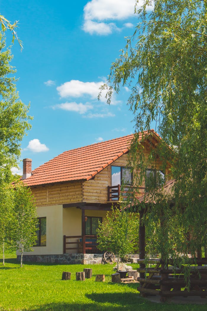 services-02 Discover a picturesque rustic house surrounded by vibrant greenery in a serene summer landscape.