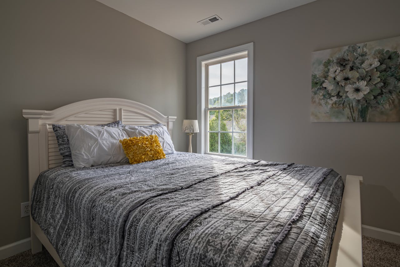 cta-02 A warm, inviting bedroom with a double bed and natural light streaming in.